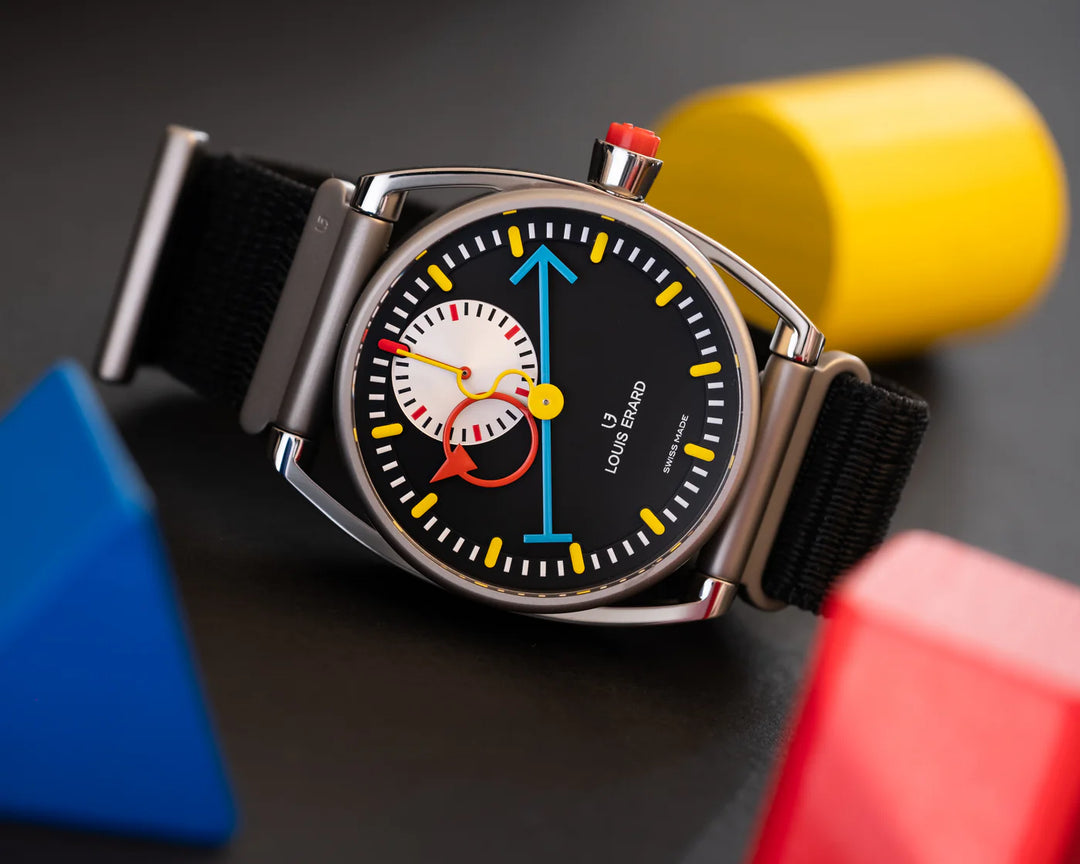 Watch with a black strap and colorful face against a dark background