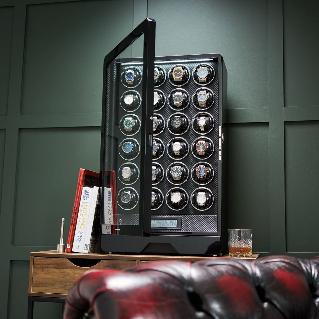 Barrington Twenty-four Watch Winder with multiple watches on a wooden table against a green wall. from barringtonwatchwinders.com - Photo 10