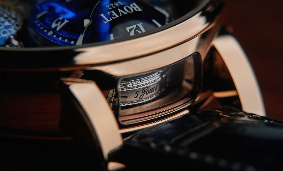 Close-up of a luxury watch with 'BOVET' branding on a dark background