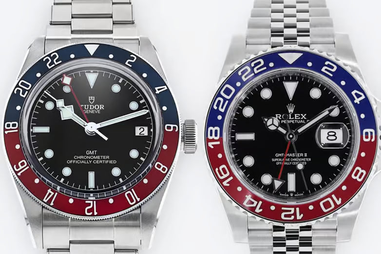 Two watches with black faces, red and blue bezels, and silver metal bands on a white background.